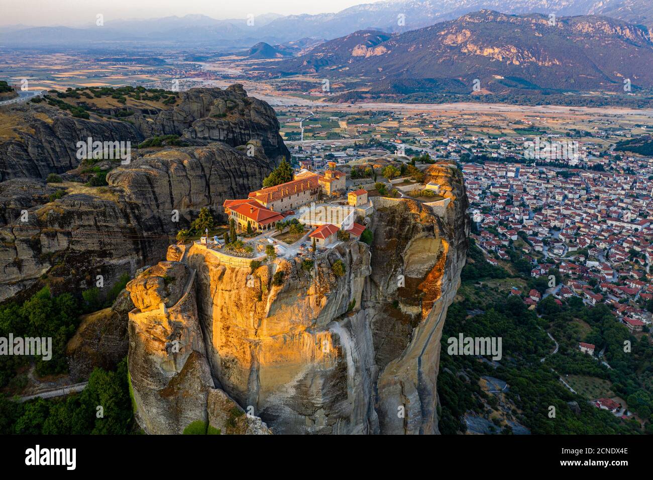 Aerial by drone of the Holy Monastery of Holy Trinity at sunrise, UNESCO World Heritage Site, Meteora Monasteries, Greece, Europe Stock Photo