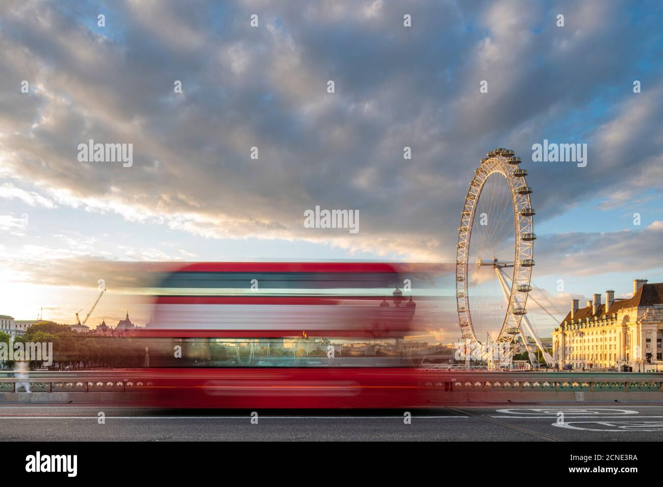 A red London bus goes past in a blur across Westminster Bridge with the London Eye and Southbank in distance, London, England, United Kingdom, Europe Stock Photo