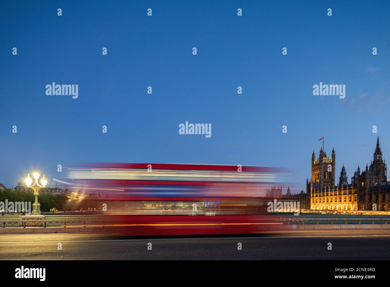 A red London bus goes past in a blur across Westminster Bridge, London, England, United Kingdom, Europe Stock Photo