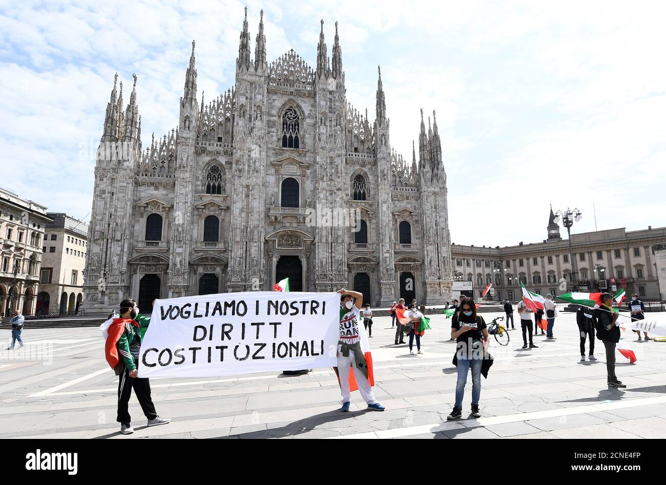 People hold a banner as they protest against the economic consequences of the lockdown at the Duomo square, as Italy begins a staged end to a nationwide lockdown due to a spread of the coronavirus disease (COVID-19), in Milan, Italy, May 4, 2020. Banner reads: 'We want our constitutional rights'. REUTERS/Flavio Lo Scalzo Stock Photo