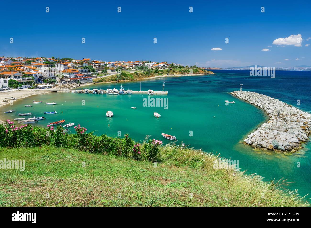 Coastal village with fishing port, hilltop view of Nea Fokaia at Kassandra peninsula with low rise buildings, Chalkidiki, Greece, Europe Stock Photo