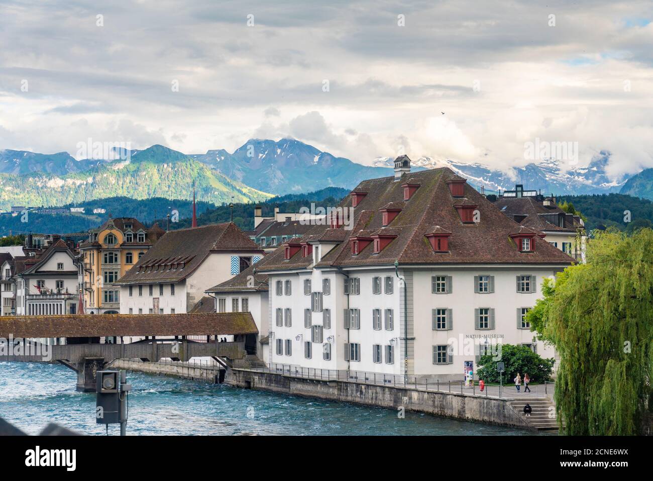 Historic old buildings with Spreuer wooden bridge on the Reuss and mountains in the background, Lucerne, Switzerland, Europe Stock Photo