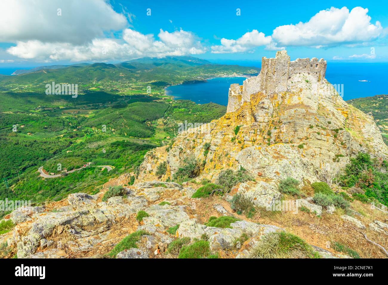 Iconic view from top of Elba mountain of Volterraio Castle on rock at 394 m, Fortress of Volterraio dominates Portoferraio Gulf Stock Photo