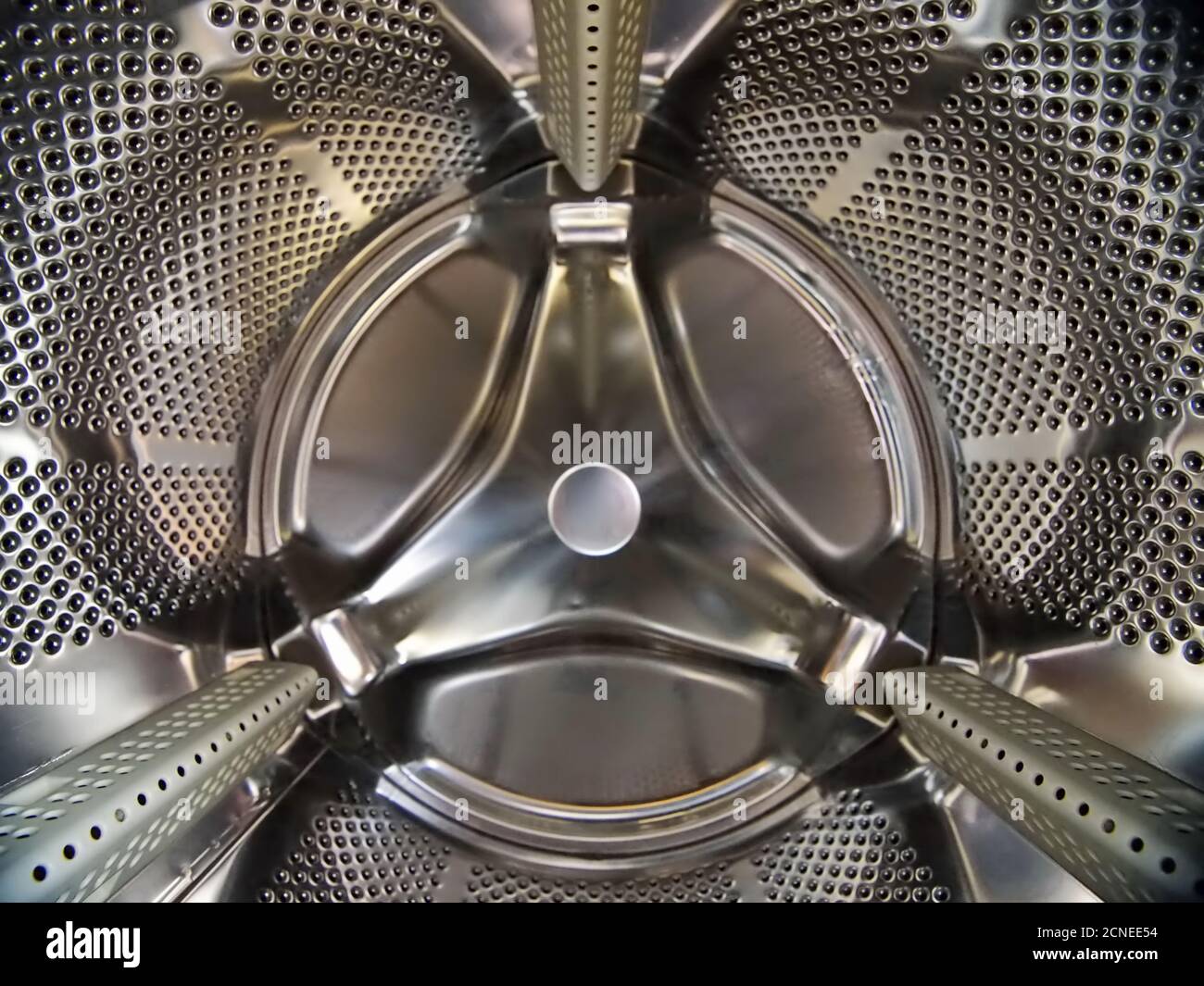 Closeup of a washing machine steel drum under the lights Stock Photo