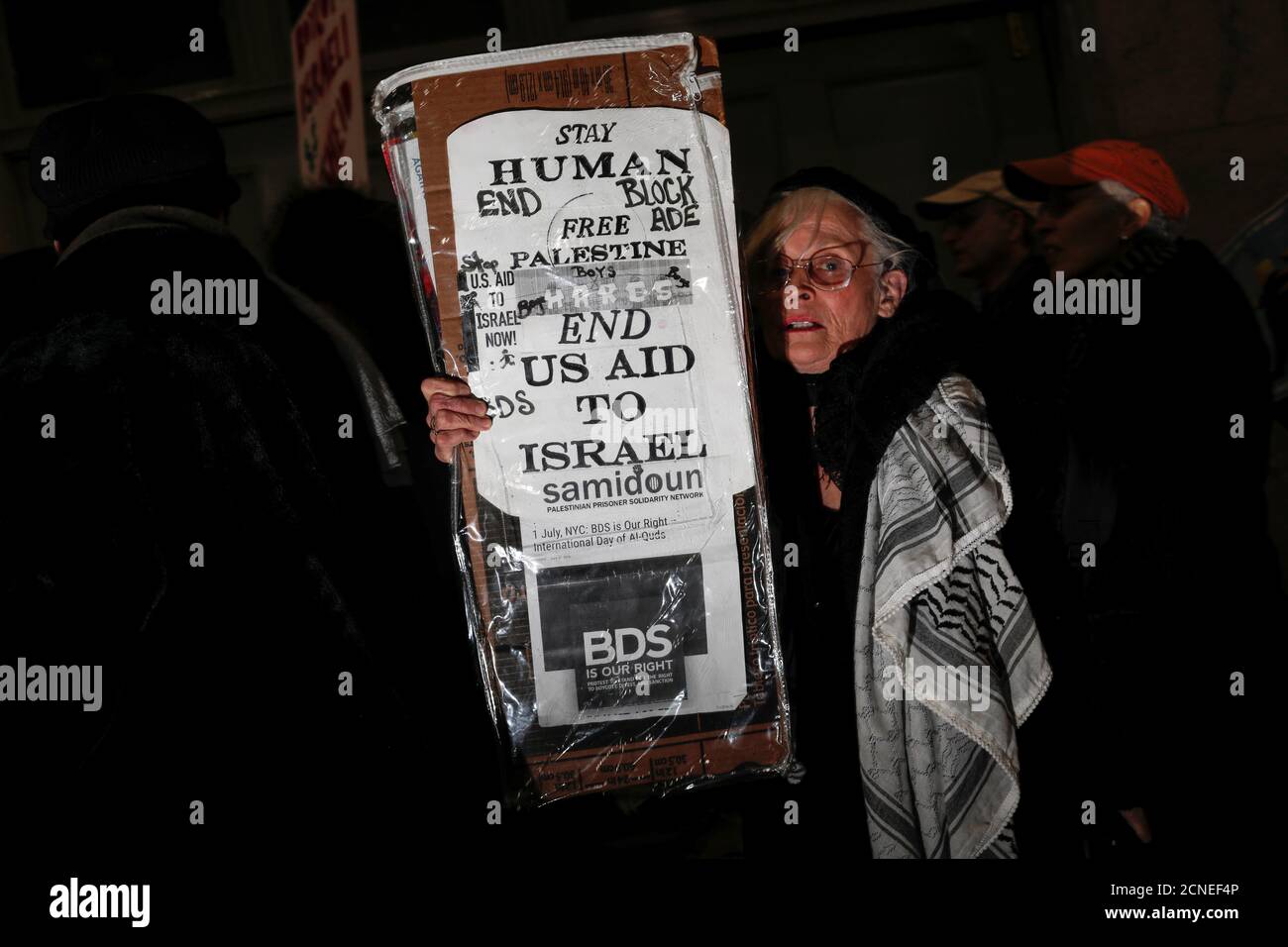 A woman holds a sign during a 'Muslim and Jewish Solidarity' demonstration protesting the policies of U.S. President Donald Trump and Israeli Prime Minister Benjamin Netanyahu at Grand Central Terminal in New York City, U.S., February 15, 2017. REUTERS/Mike Segar Stock Photo