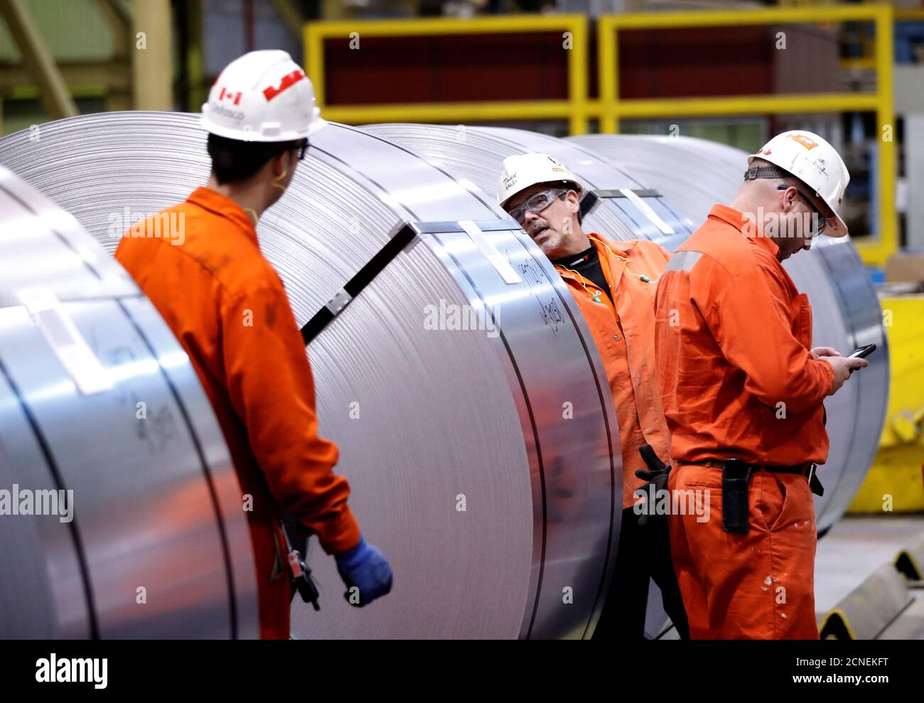workers-look-at-rolls-of-steel-at-the-arcelormittal-dofasco-steel-plant-in-hamilton-ontario-canada-march-13-2018-reuters-mark-blinch-stock-photo-alamy
