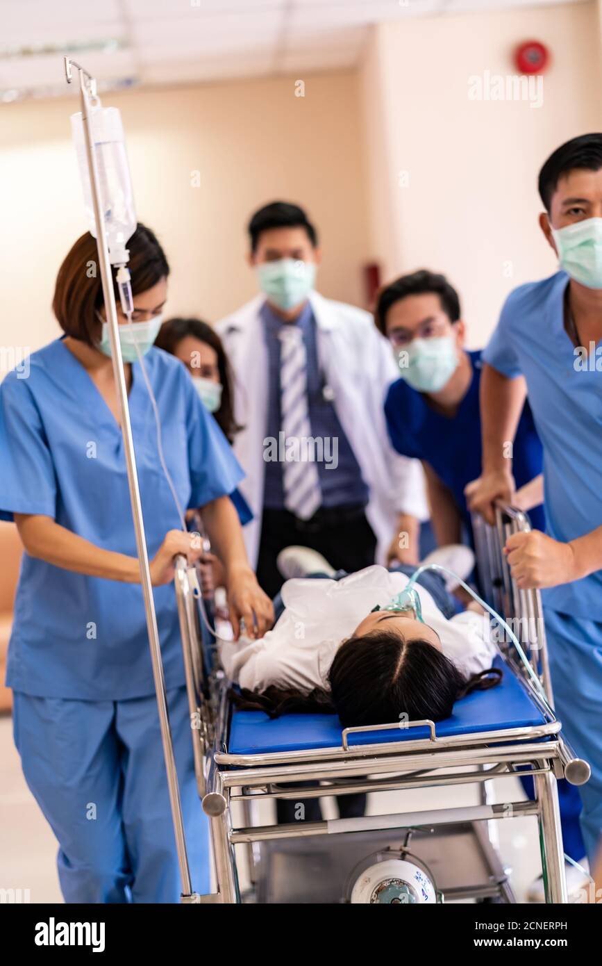 Medical team push gurney with injured patient Stock Photo