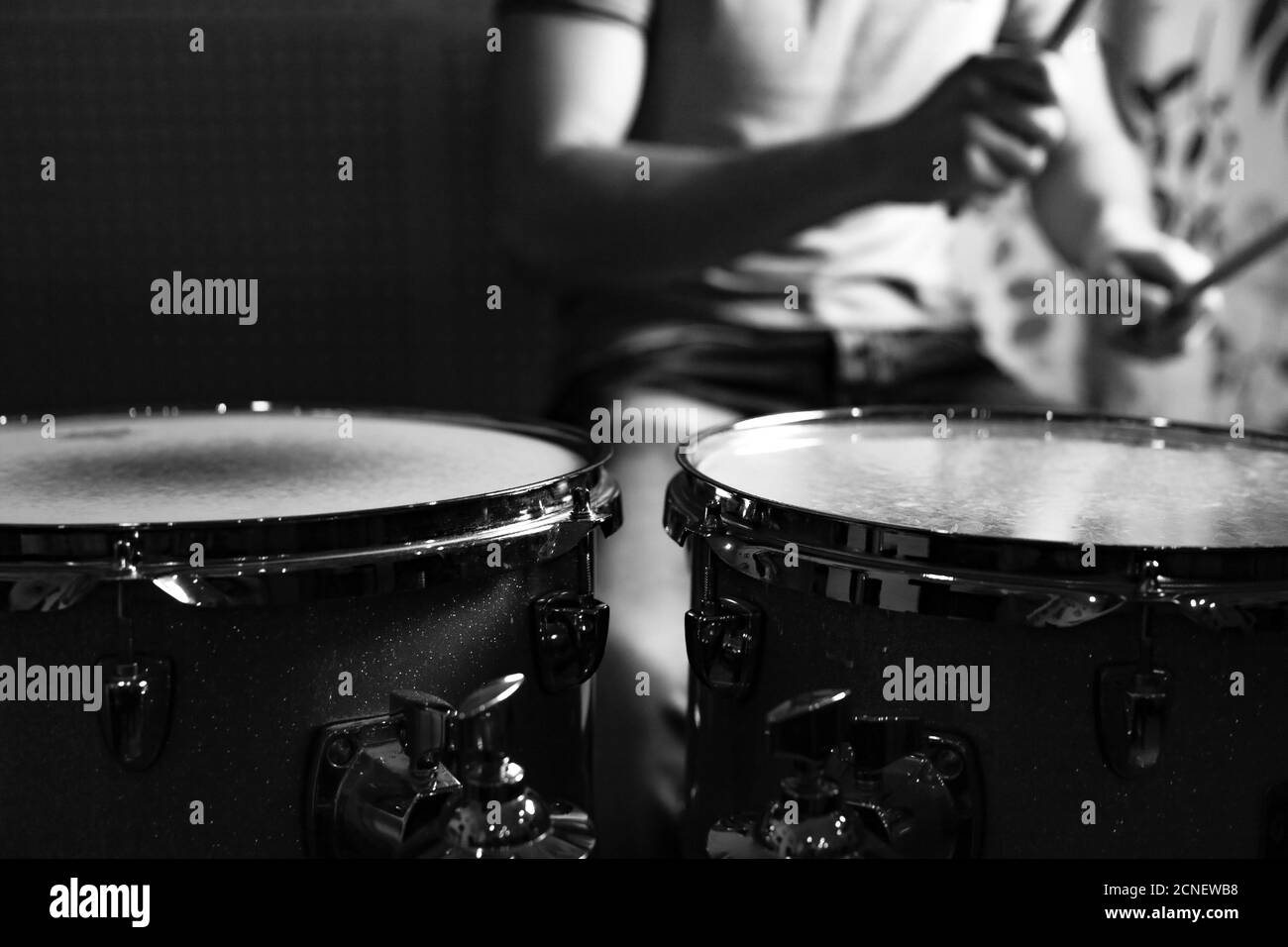 Drummer beats drums with drumsticks, close-up photo. Focus on the drums. Stock Photo