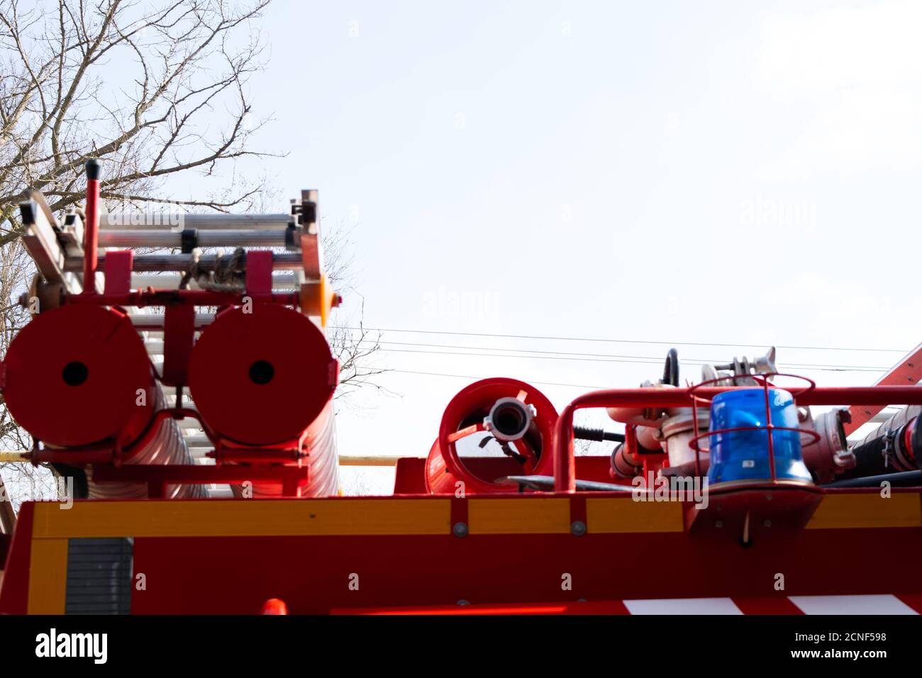 a fire truck, rear view of canisters for transporting suction hoses with fire escapes attached to them, copy space Stock Photo