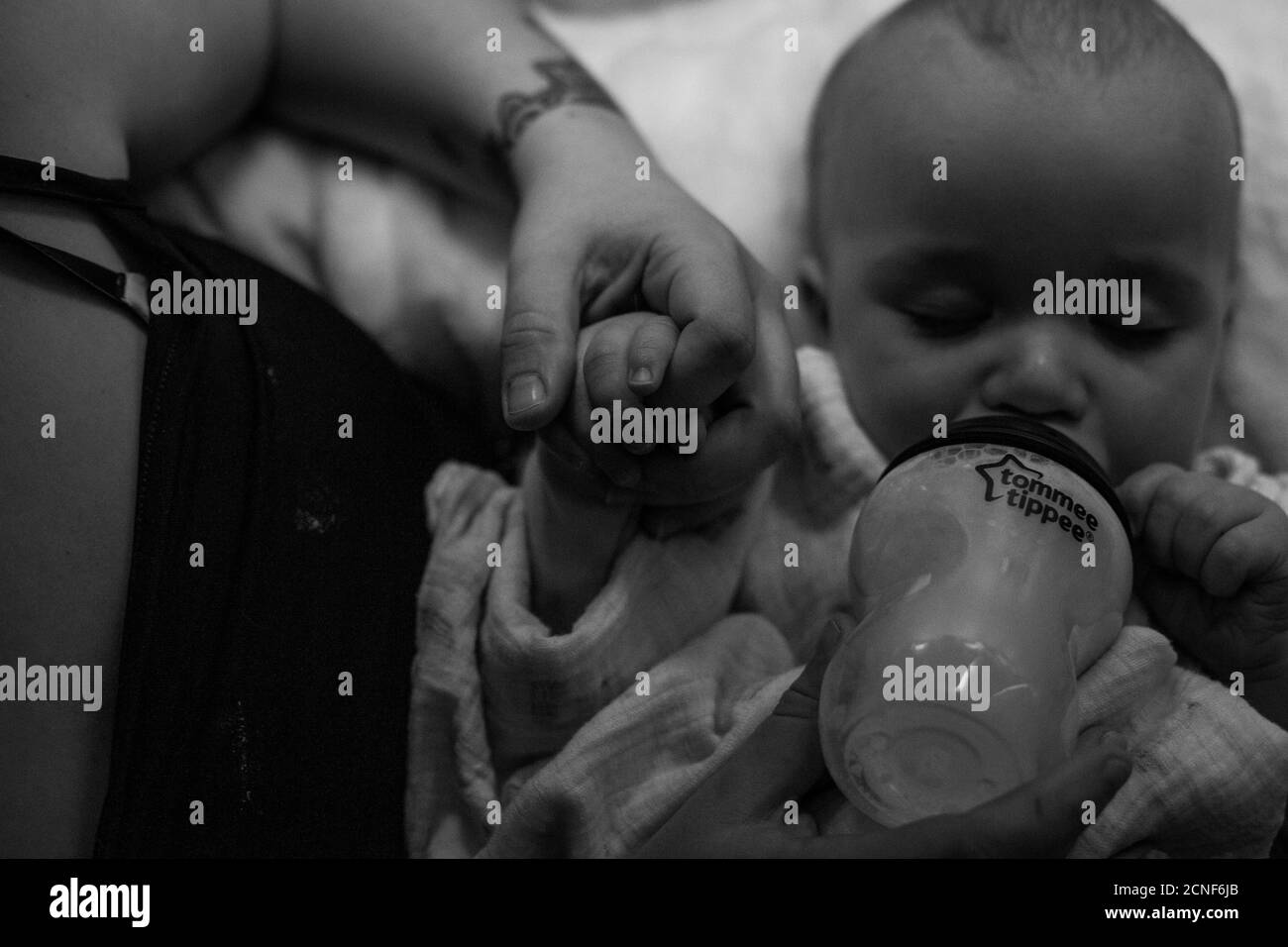 Baby being bottle fed milk before bed Stock Photo Alamy