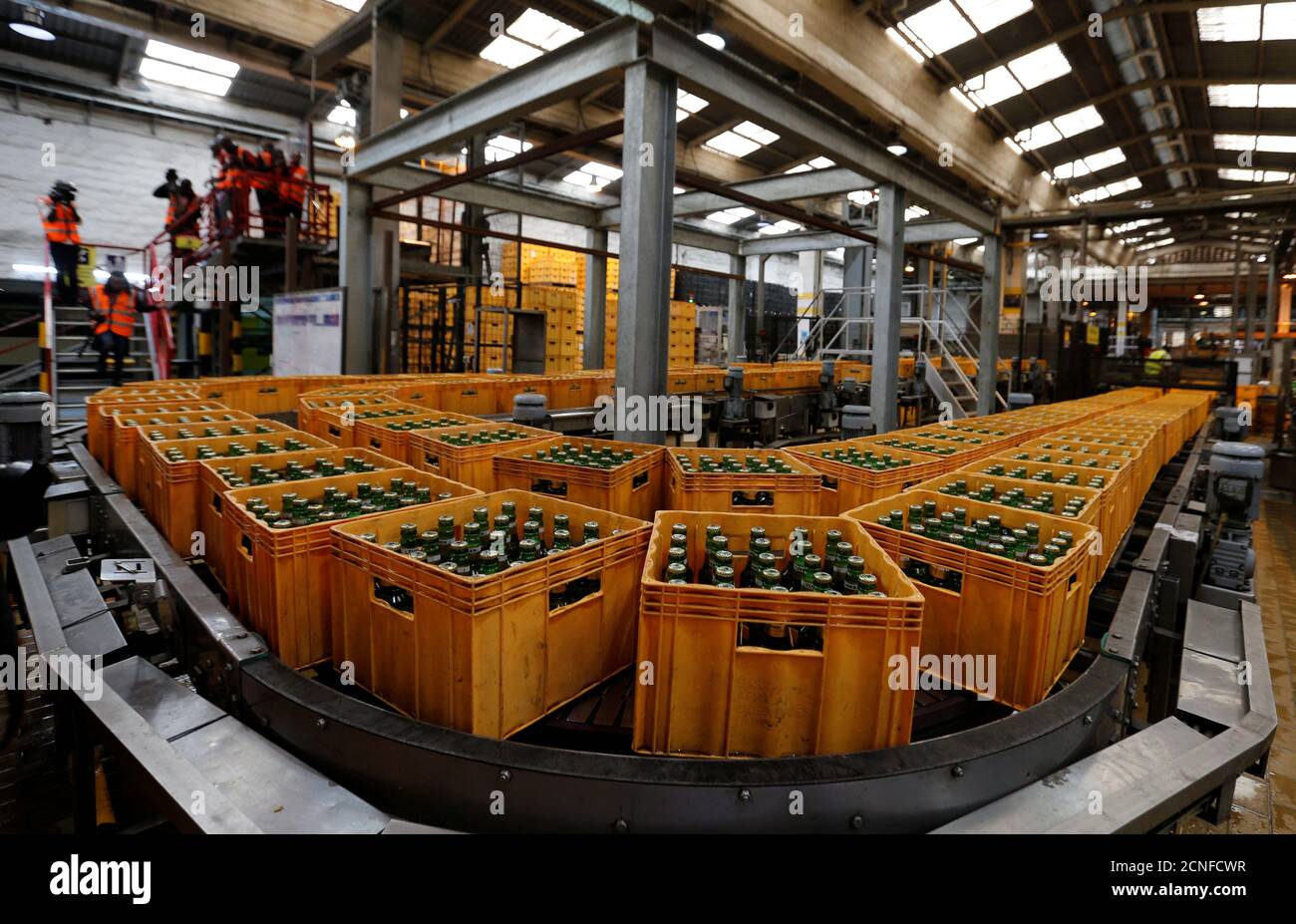 Crates of Tusker Malt beer are seen on a conveyor belt at the East