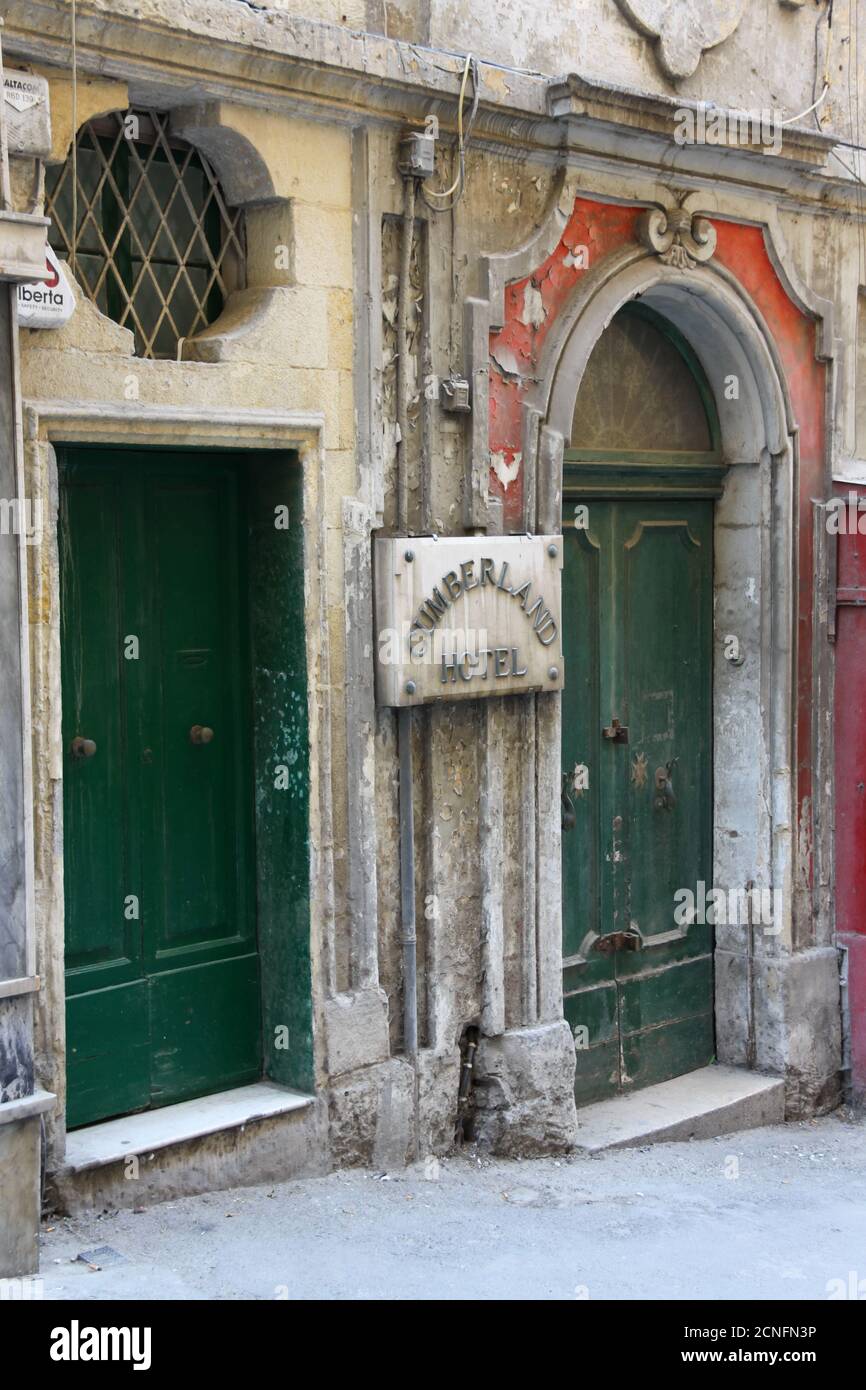 Worn, weathered old green doors in the centre of Valletta, Malta Stock Photo