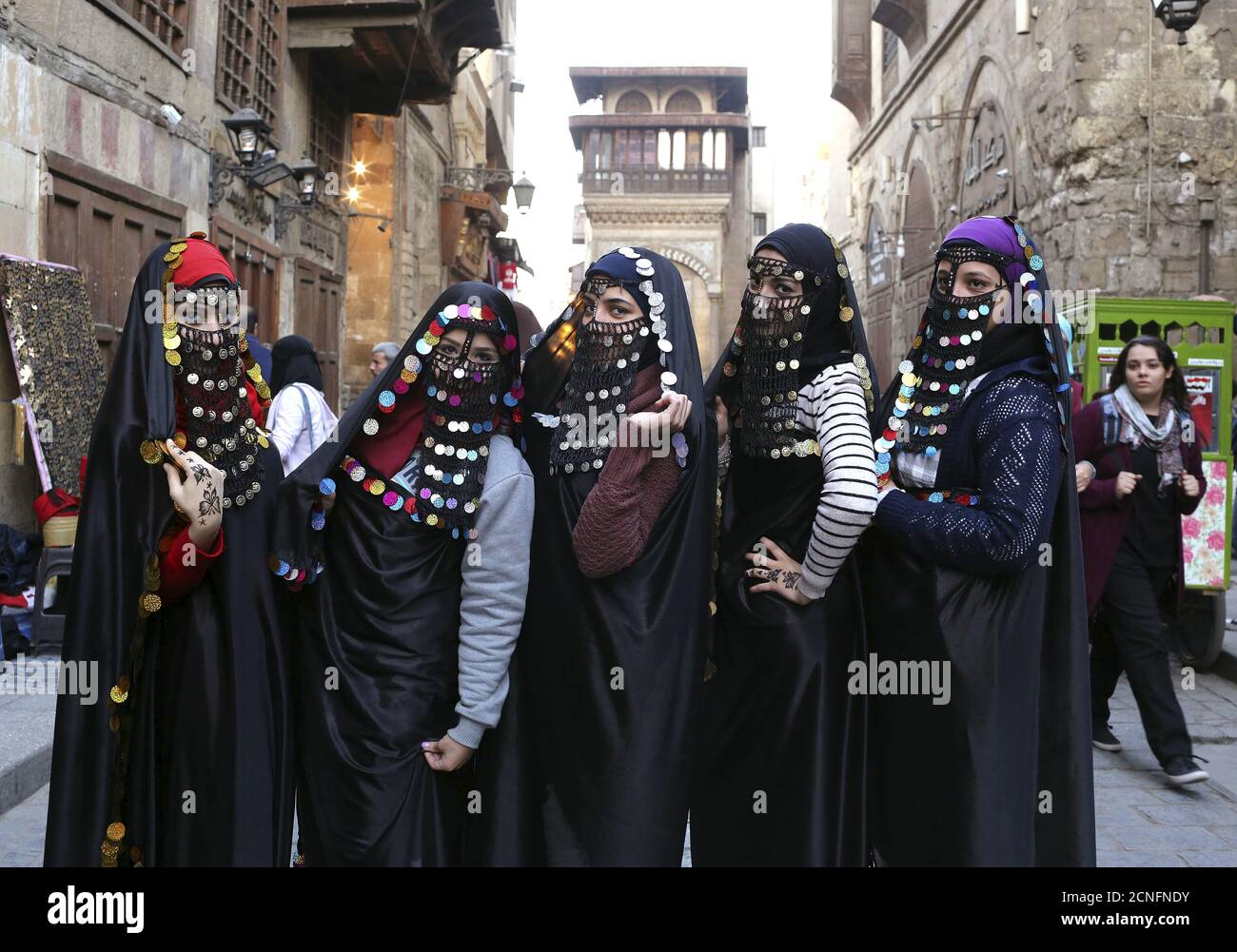 Girls dressed up in traditional Egyptian clothes from the early 20th century pose for a picture before they get their photos taken on the historical Al-Moez street of Islamic Cairo, Egypt, January 17, 2016.  REUTERS/Asmaa Waguih Stock Photo