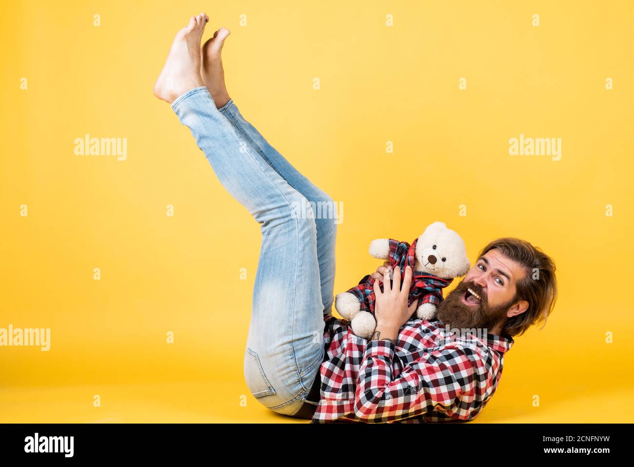 being playful. male feel playful with bear. brutal mature hipster man play with toy. happy birthday. being in good mood. happy valentines day. cheerful bearded man hold teddy bear. Stock Photo