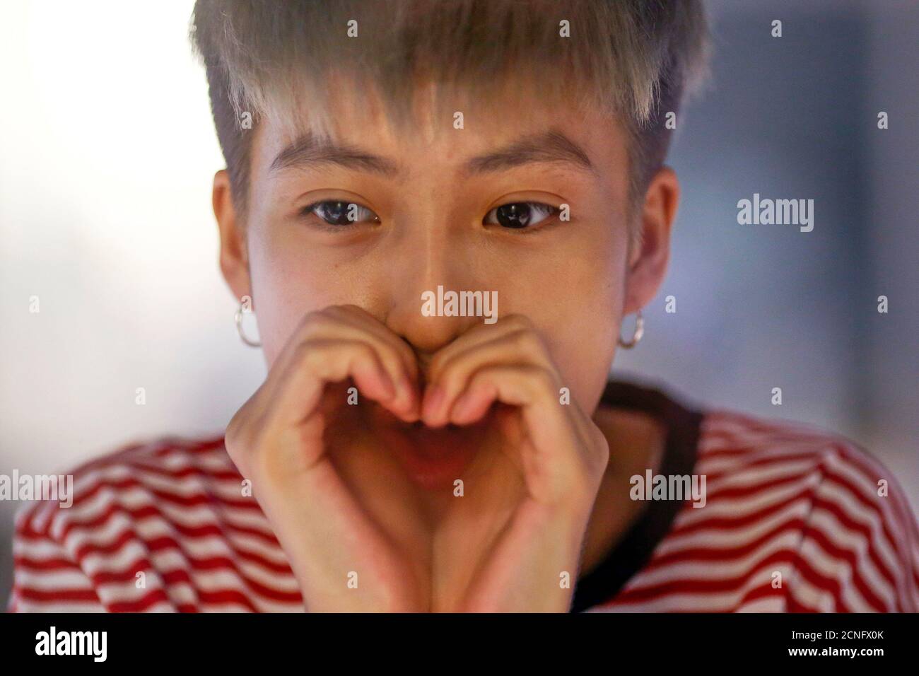 A member of China's all-girl 'boyband' FFC-Acrush blows a heart shape onto a glass panel in Beijing April 27, 2017.  Picture taken April 27, 2017.   REUTERS/Thomas Peter Stock Photo