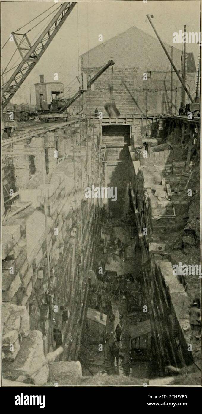 . The street railway review . il coniieilionto the wheel pit and a short tunnel circular in sliapi- and 10ft. in diameter which was provided with a  ii lo llie pos-sible development of lan&lt;ls owned by the c()ni|)any on thenorth side of the tunnel. The average slope of the main tunnel is 6 ft. in i,i)()(); it 662 ^tifidSfeiib^%v%V was (Iconuil best to lower ihc portal so that a considi-ralilcportion of the iliseharsfe might he under water, and 90 ft.from the portal the grade is changed to an ogee, droppingII ft. in that distance. The slope gives a velocity of 26)2ft. per second or about Stock Photo