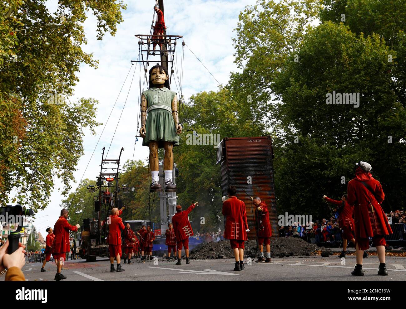A giant animated puppet of a girl, part of a performance by French