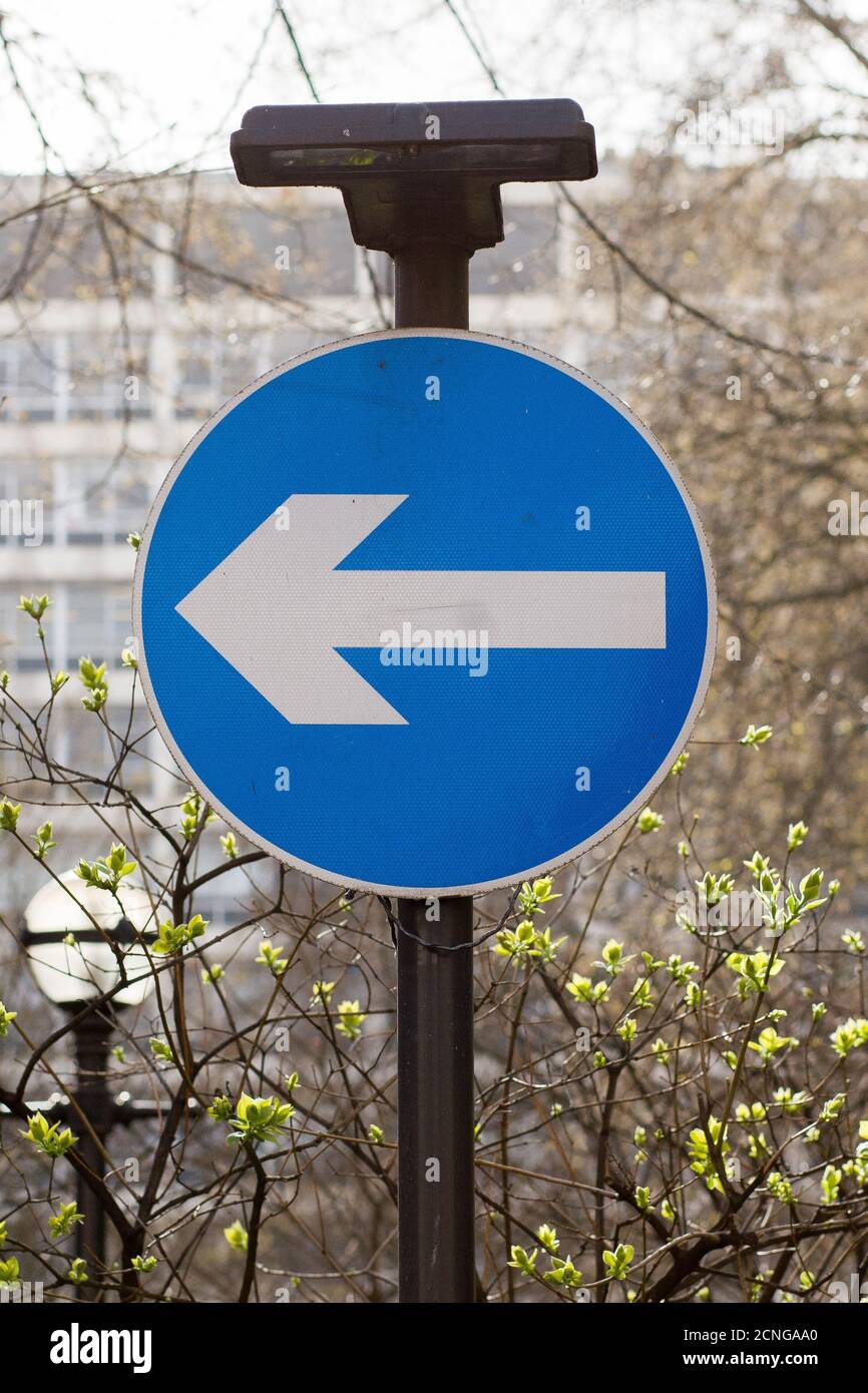 Street sign instructing motorist to turn left or move in a clockwise direction around a one way system or roundabout. 01 April 2009. Photo: Neil Turne Stock Photo