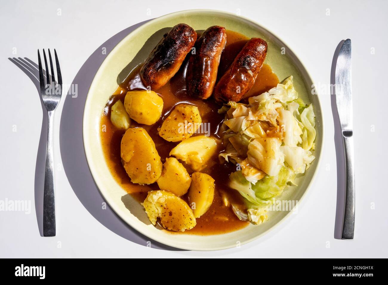 Sausages boiled potatoes and cabbage with gravy Stock Photo