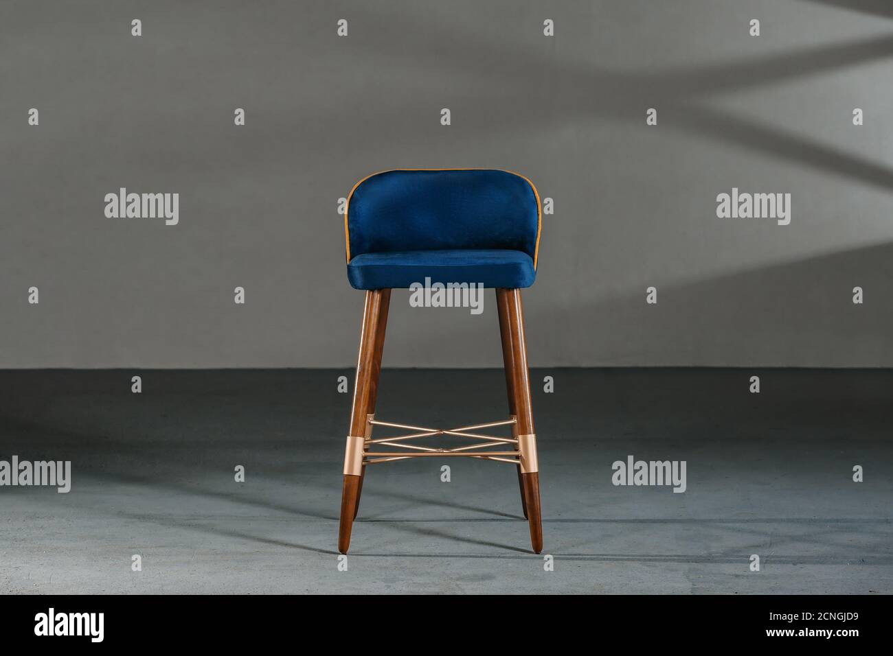 Blue dining room chair in a studio with gray walls Stock Photo Alamy