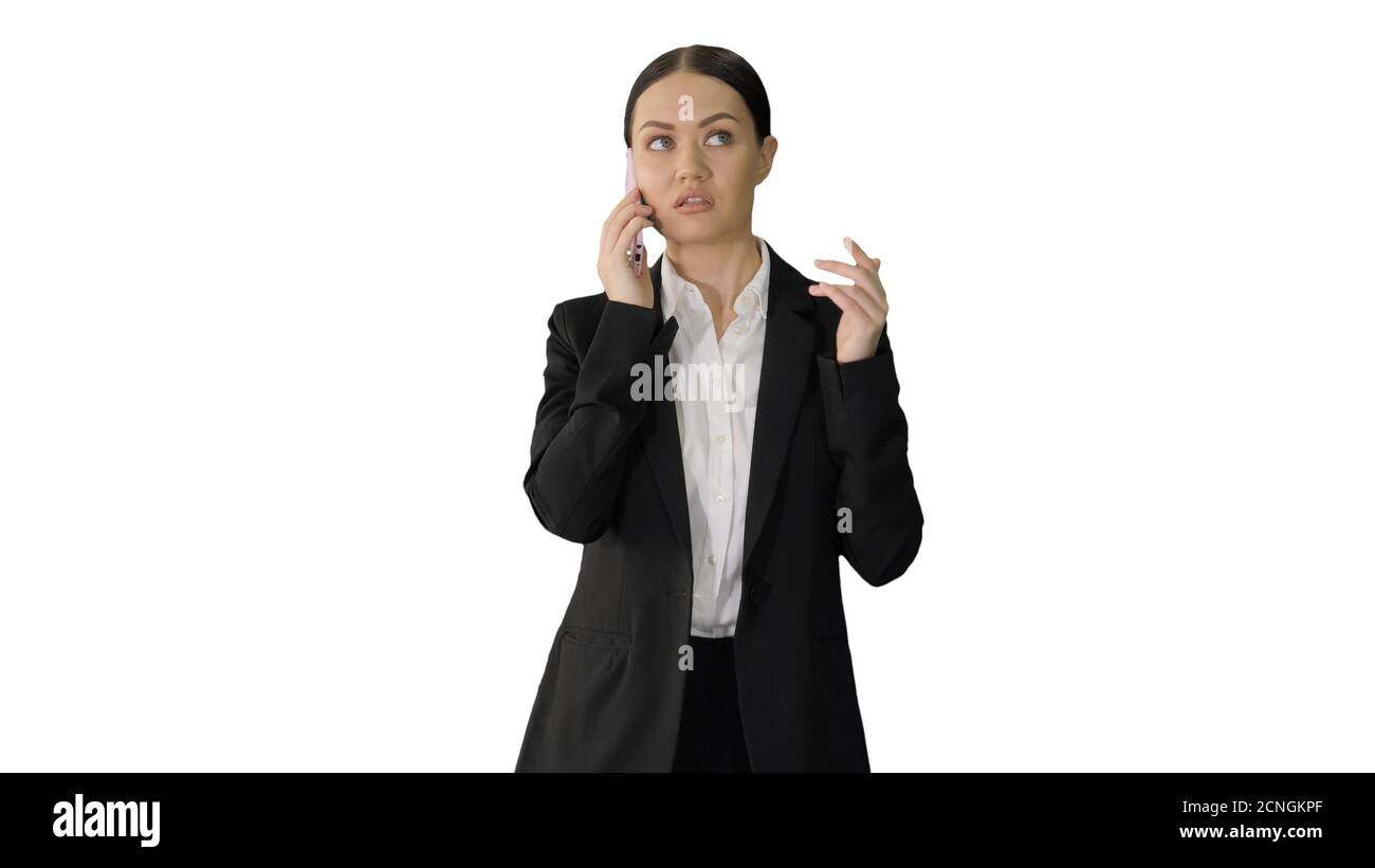 Bossy Businesswoman talking on her phone on white background. Stock Photo