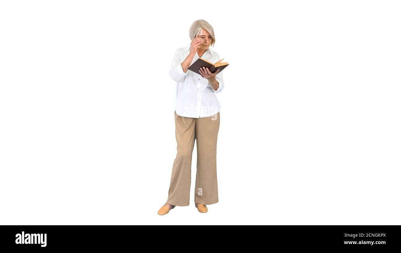 Old lady standing and reading a book on white background. Stock Photo