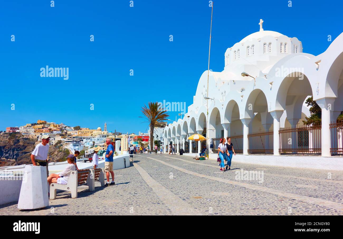 Fira, Santorini island, Greece - April 25, 2018: Promenade with walking people near Metropolitan Cathedral in Fira (Thera) Stock Photo
