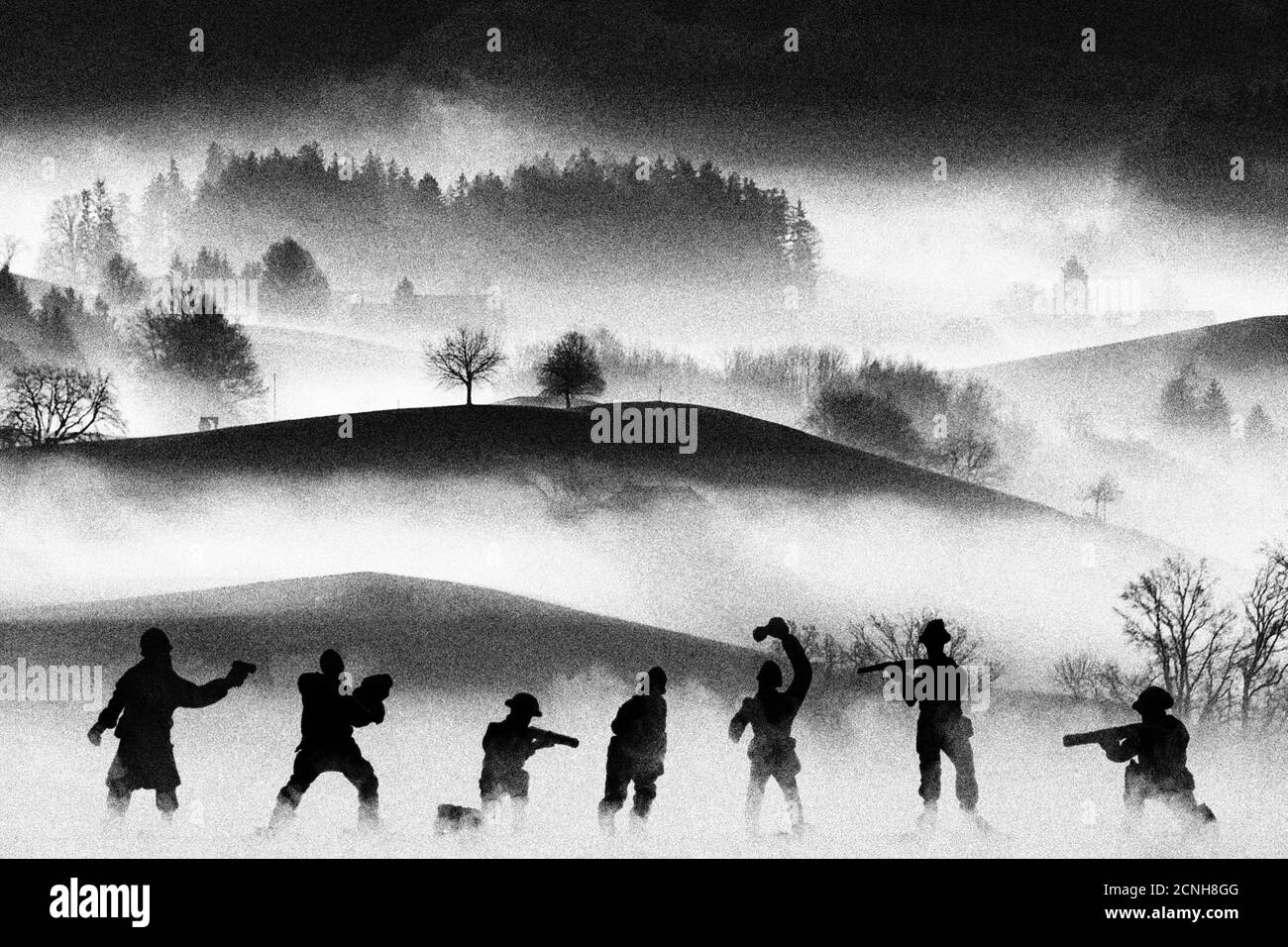 War concept. Vintage military silhouettes fighting scene  background, Civil war soldiers silhouettes attack scene in a foggy landscape. Analog film lo Stock Photo