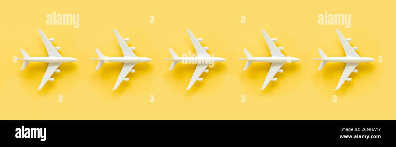 White model plane, airplane on yellow background. Banner. Stock Photo