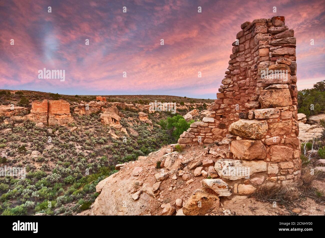 Eroded Boulder House, with Twin Towers and Rim Rock House in distance, at sunrise, Hovenweep National Monument, Colorado Plateau, Utah, USA Stock Photo