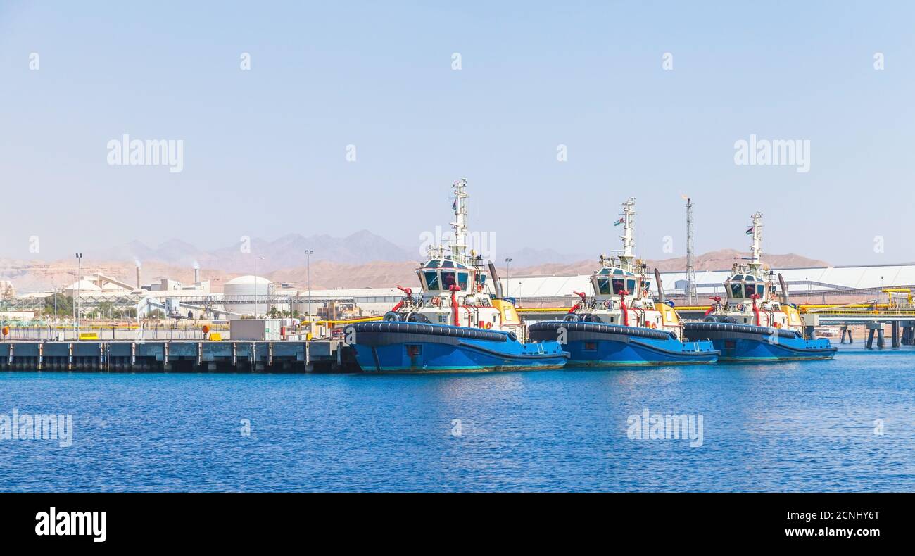 Tug boats are moored in Aqaba Port at sunny day, Jordan Stock Photo