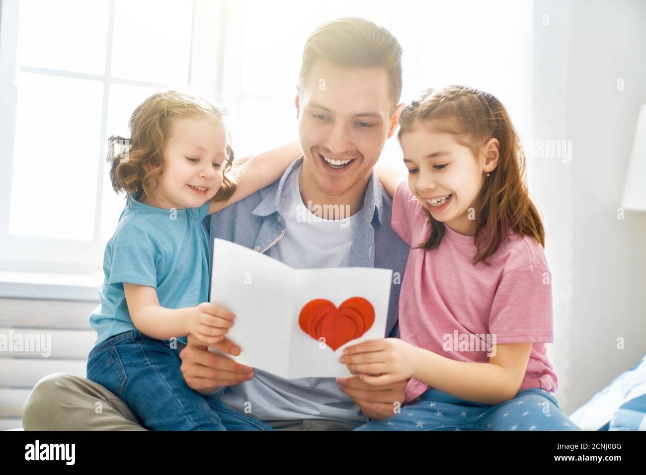 Happy father's day! Children daughters congratulating dad and giving ...