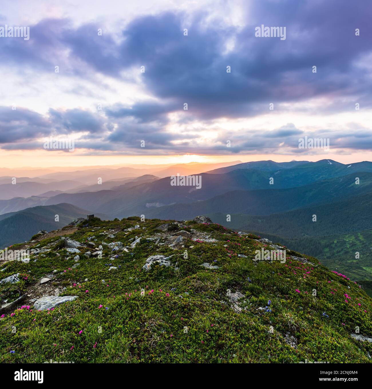 Amazing mountain landscape with colorful vivid sunset on the cloudy sky ...