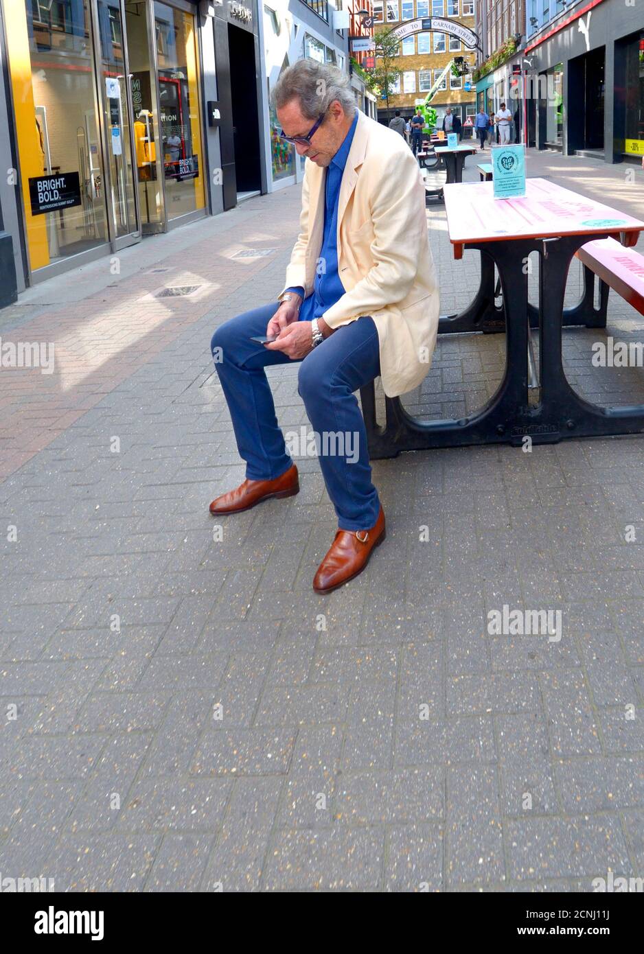 London, England, UK. Man on his mobile phone in Carnaby Street Stock Photo