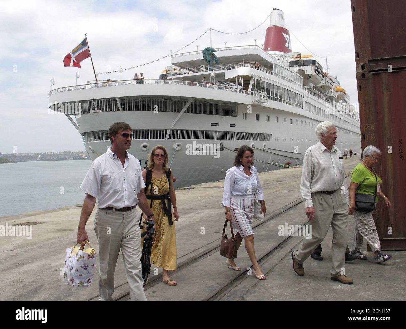 Tourists from the Norwegian cruise ship 'Black Watch Nassau' disembark at the Kenyan coastal sea port of Mombasa after the ship docked at the port in this February 8, 2007 file photo. Black Watch Nassau is on a stopover for three days in Mombasa, started its voyage at the Southampton in Britain with 807 passengers and 350 crew. East Africa's biggest port of Mombasa will spend 100 million shillings ($980,392.16) to build a new cruise ship terminal aimed at boosting tourism, port management said on Wednesday. REUTERS/Joseph Okanga/File Stock Photo