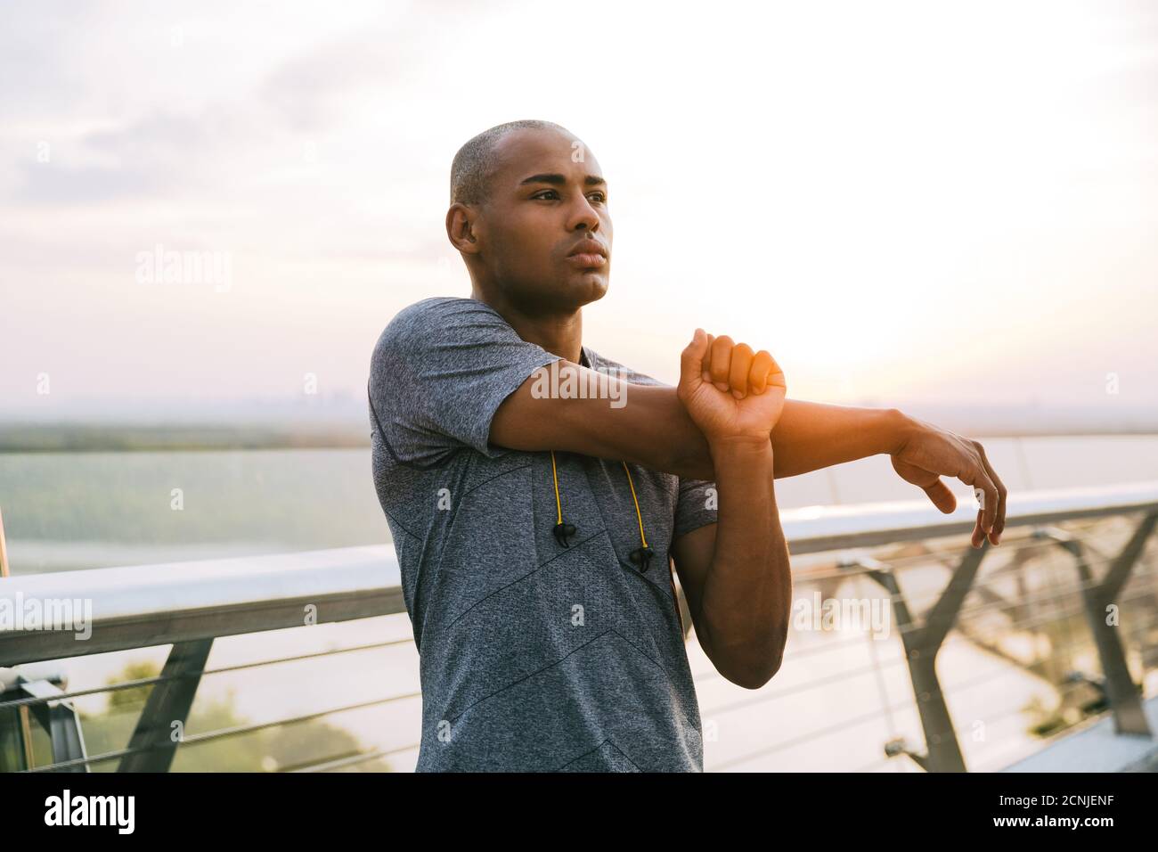 Young man stretching on bridge hi-res stock photography and images - Alamy