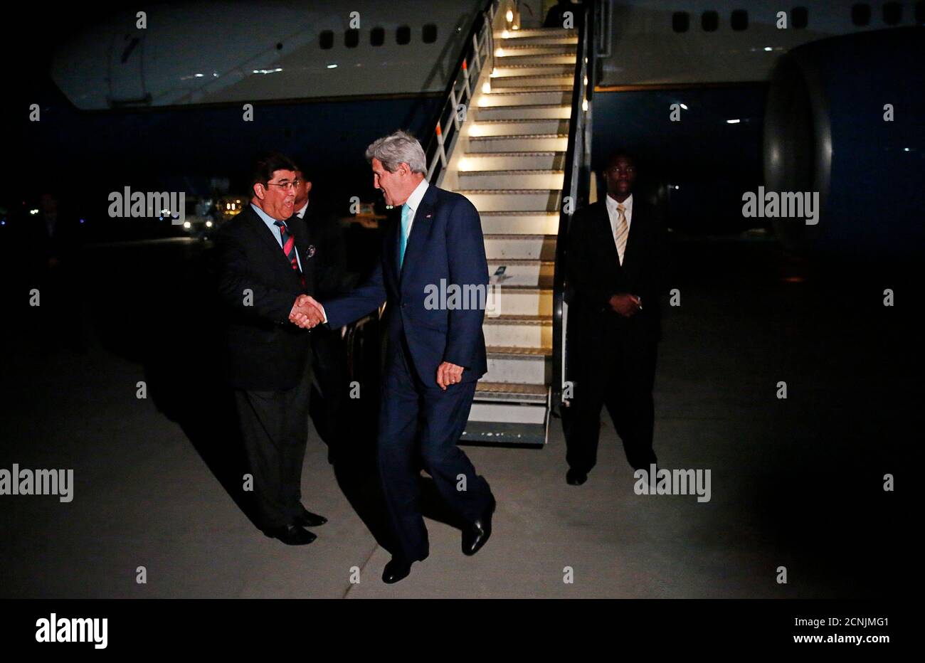 U.S. Secretary of State John Kerry is greeted by Afghanistan's Ministry of Foreign Affairs chief of protocol Ambassador Hamid Siddiq (L) as Kerry arrives at Kabul International airport in Kabul, July 11, 2014. Kerry is expected to meet with Afghanistan's President Kharzai as well as both candidates in Afghanistan's recent presidential election.  REUTERS/Jim Bourg    (AFGHANISTAN - Tags: POLITICS) Stock Photo