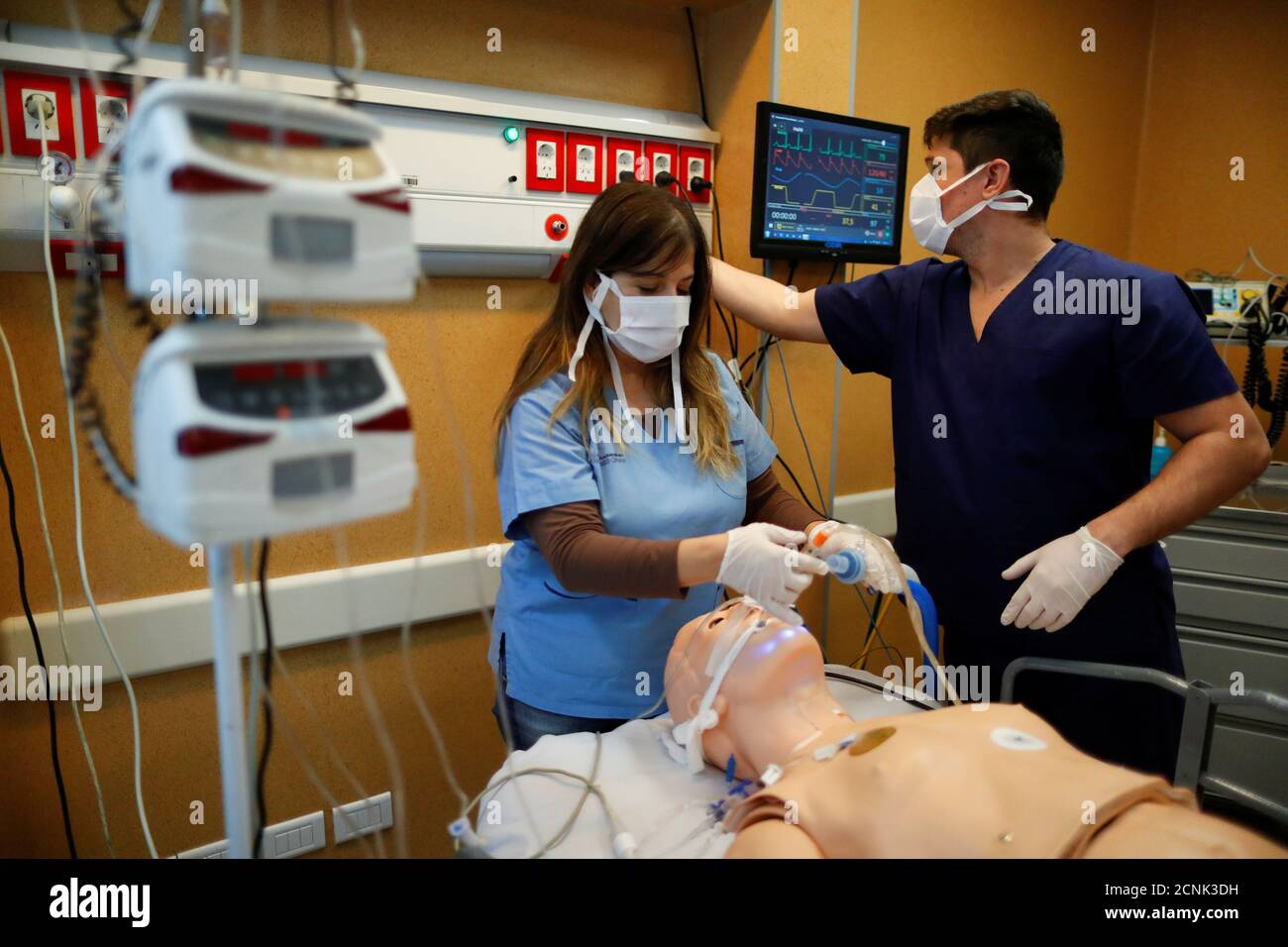 Pediatric specialist Norma Raul attaches a respirator system for training  reasons to a dummy at the El Cruce hospital, as the spread of the  coronavirus disease (COVID-19) continues, in Florencio Varela, on