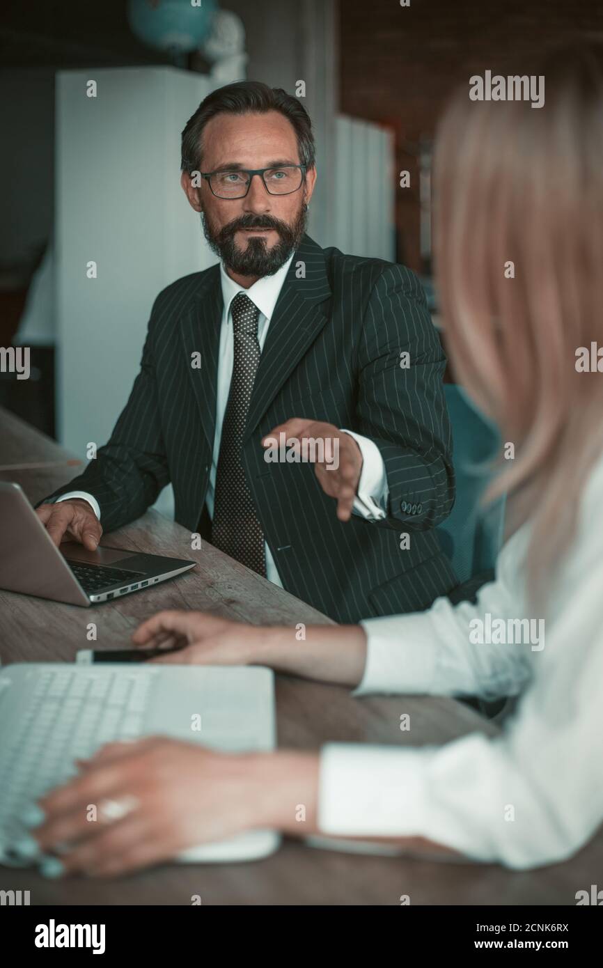 Manager in the office explains the working moments to the employee of ...