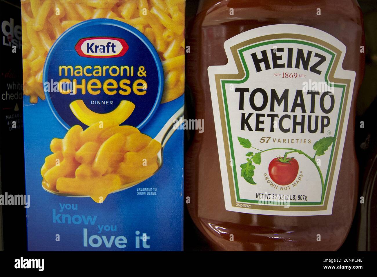 A box of Kraft macaroni and cheese and a Heinz Ketchup bottle are displayed together on a grocery store shelf in New York March 25, 2015. Kraft Foods Group Inc, the maker of Velveeta cheese and Oscar Mayer meats, will merge with ketchup maker H.J. Heinz Co, owned by 3G Capital and Berkshire Hathaway Inc, to form the world's fifth-largest food and beverage company. REUTERS/Brendan McDermid Stock Photo