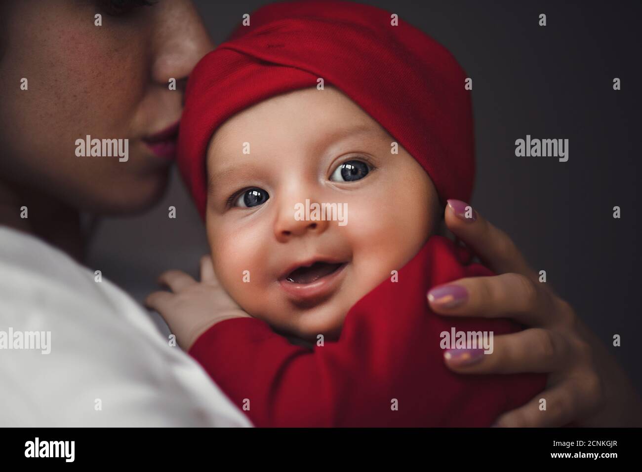 Mother holding cute newborn baby girl in her arms. Stock Photo