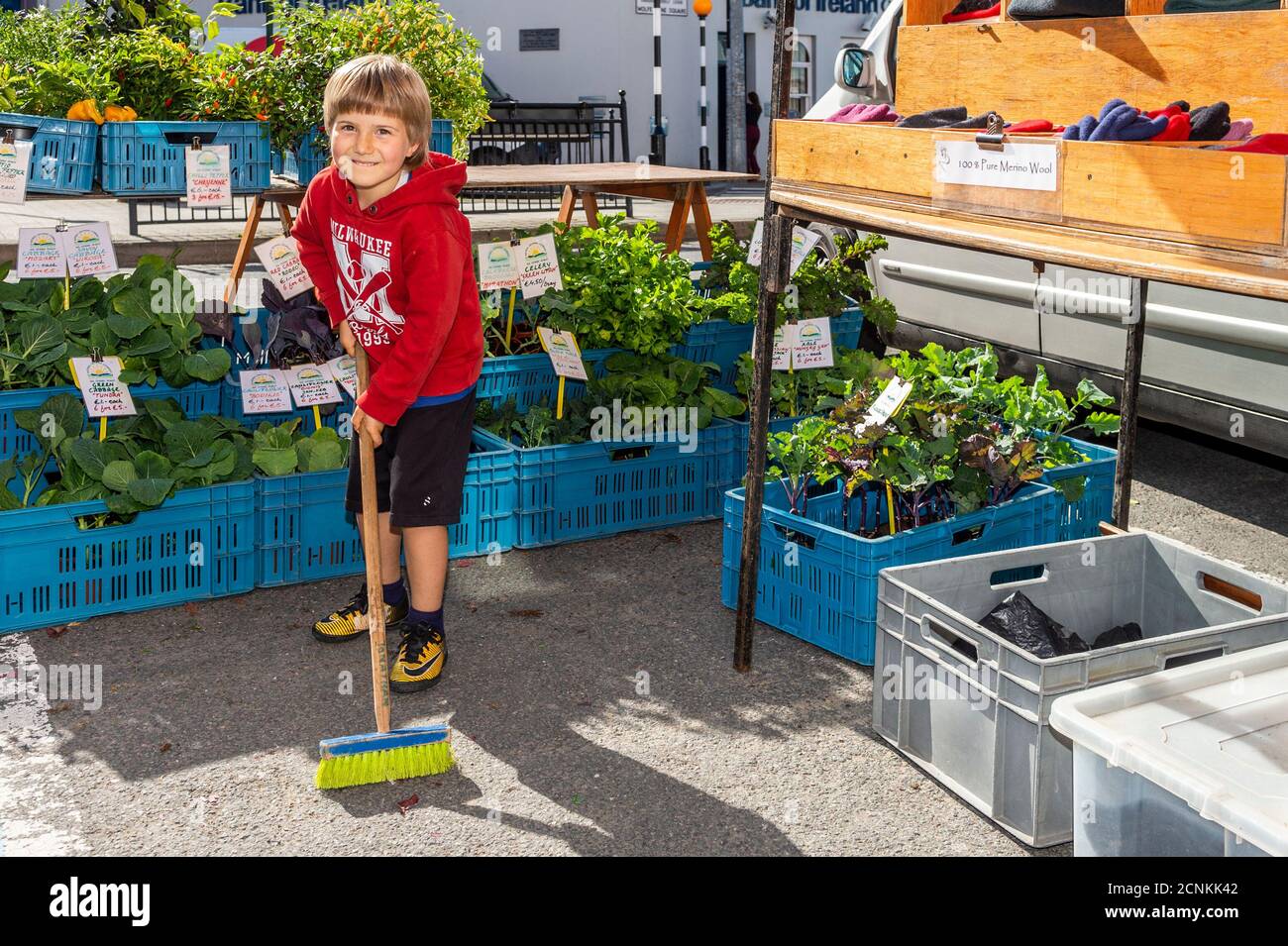 Bantry, West Cork, Ireland. 18th Sep, 2020. On a hot and sunny day in Bantry, the Friday Market was very busy with locals and tourists alike. Helping his mother to clean up her stall was Jonathan Schultz from Bantry. Credit: AG News/Alamy Live News Stock Photo