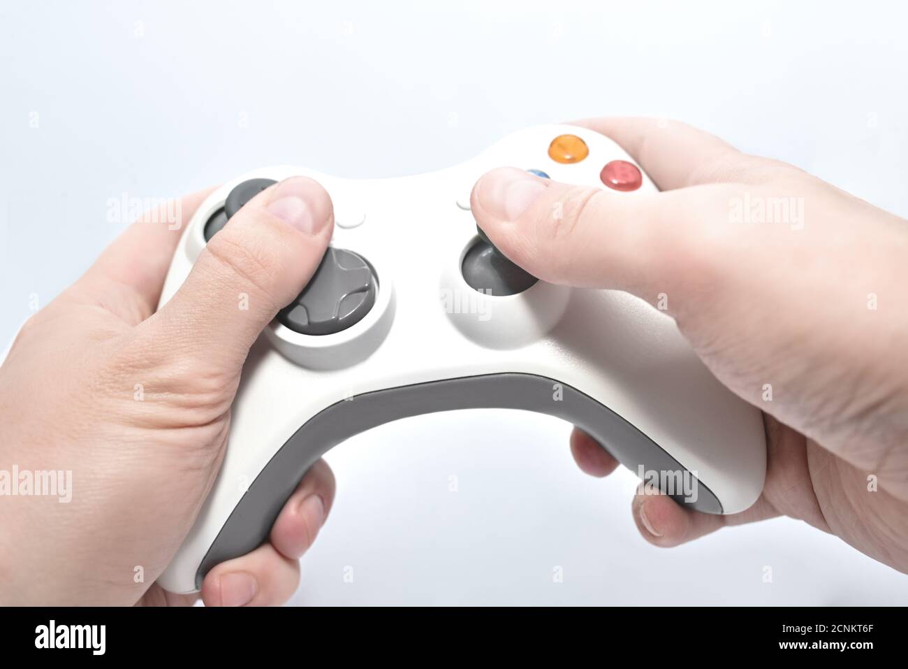 joystick gamepad in the player's hands isolated on white background. entertainment concept Stock Photo