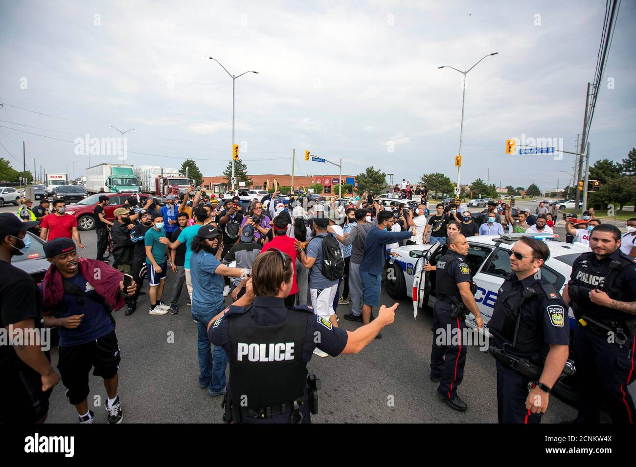 Protestors vent at police while demonstrating against the June 20 shooting death by Peel Regional Police of Ejaz Ahmed Choudry, 62, who family members say suffered from schizophrenia in Malton, Ontario, Canada June 22, 2020. REUTERS/Carlos Osorio Stock Photo