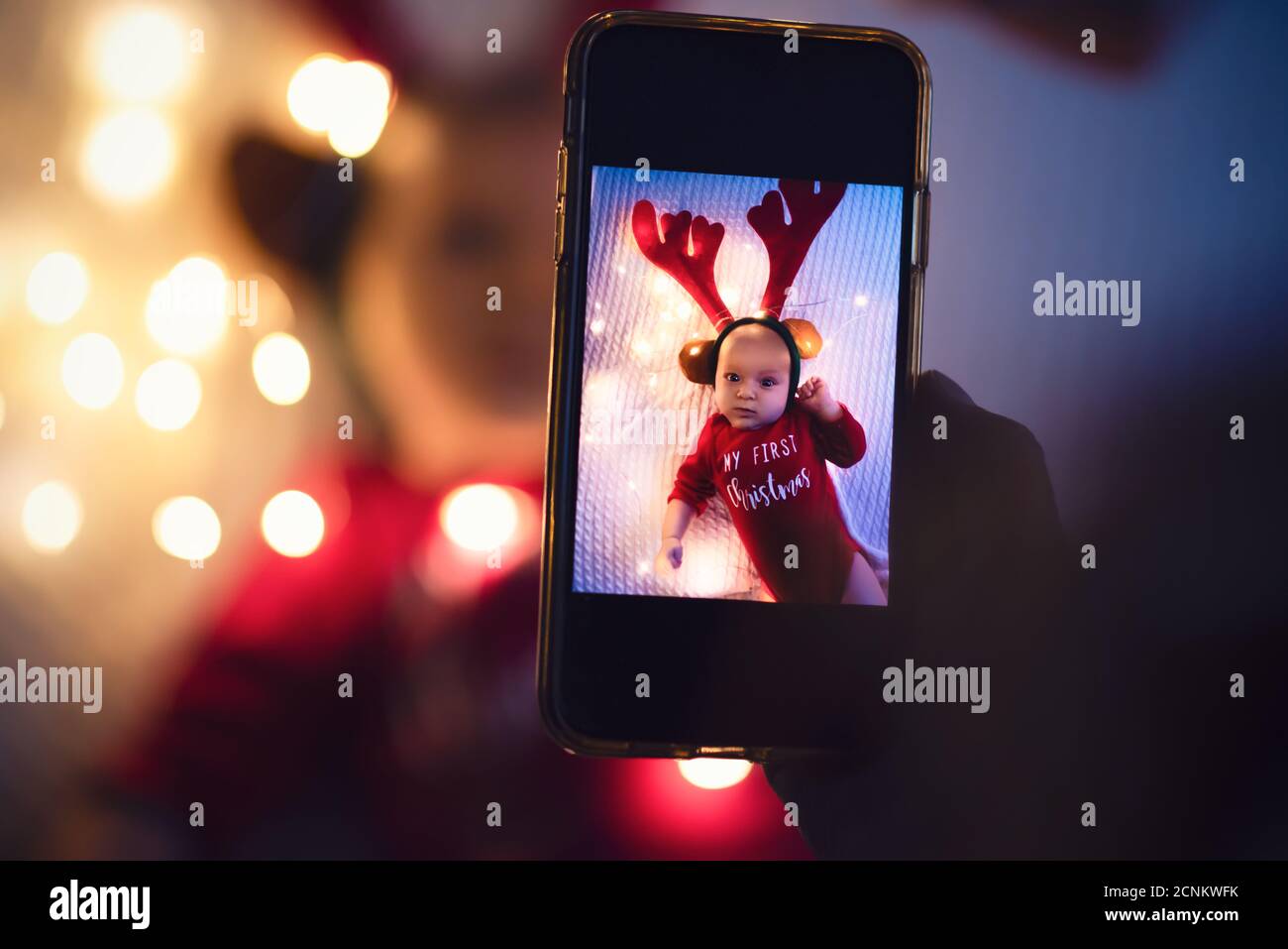 Parent taking photo of a baby with smartphone. Digital family memories. Stock Photo