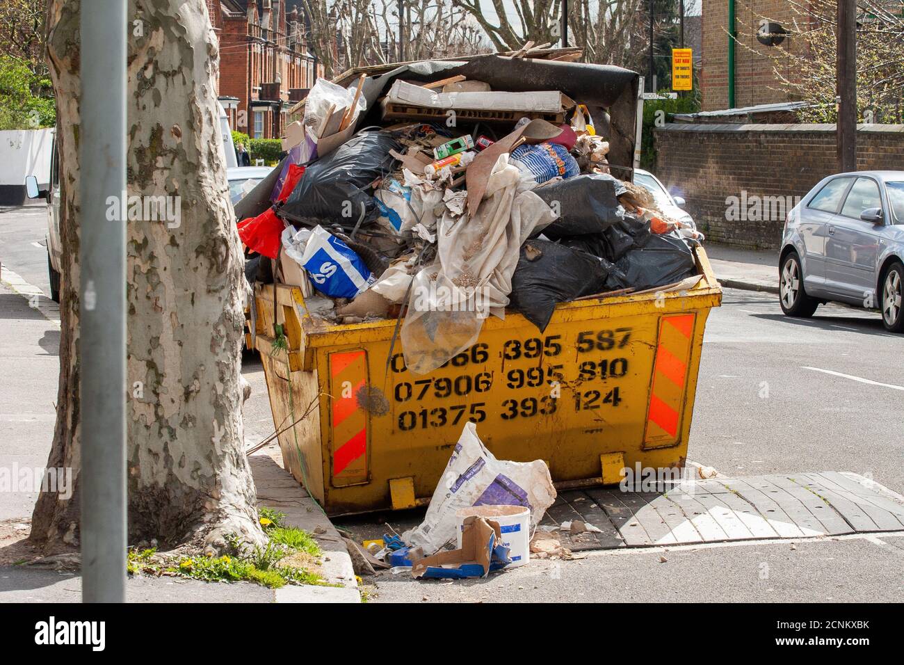 Messy Skip Overflowing skip hi-res stock photography and images - Alamy