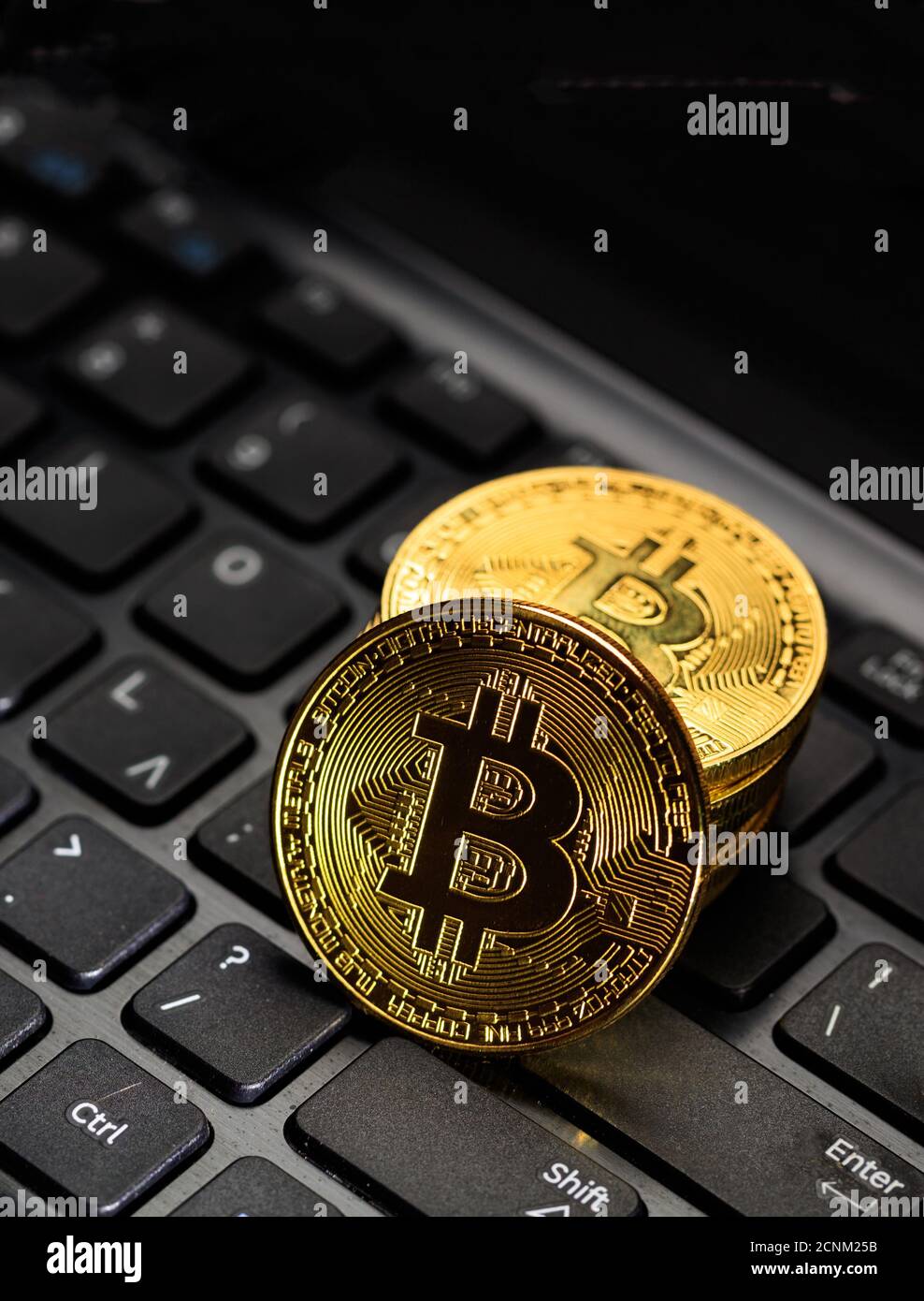 Bitcoin, btc. Crypto currency gold bit coin on computer lptop background. Blockchain technology, mining concept, vertical. 3d illustration Stock Photo