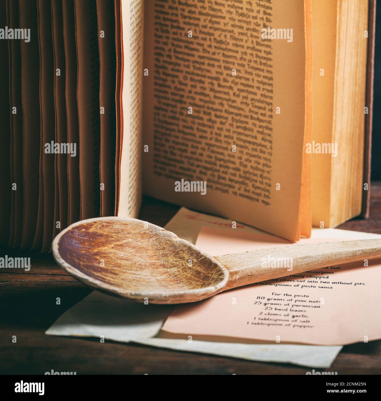 https://c8.alamy.com/comp/2CNM25N/cooking-recipe-book-on-wooden-table-background-old-vintage-cookbook-and-wooden-ladle-closeup-view-vertical-2CNM25N.jpg