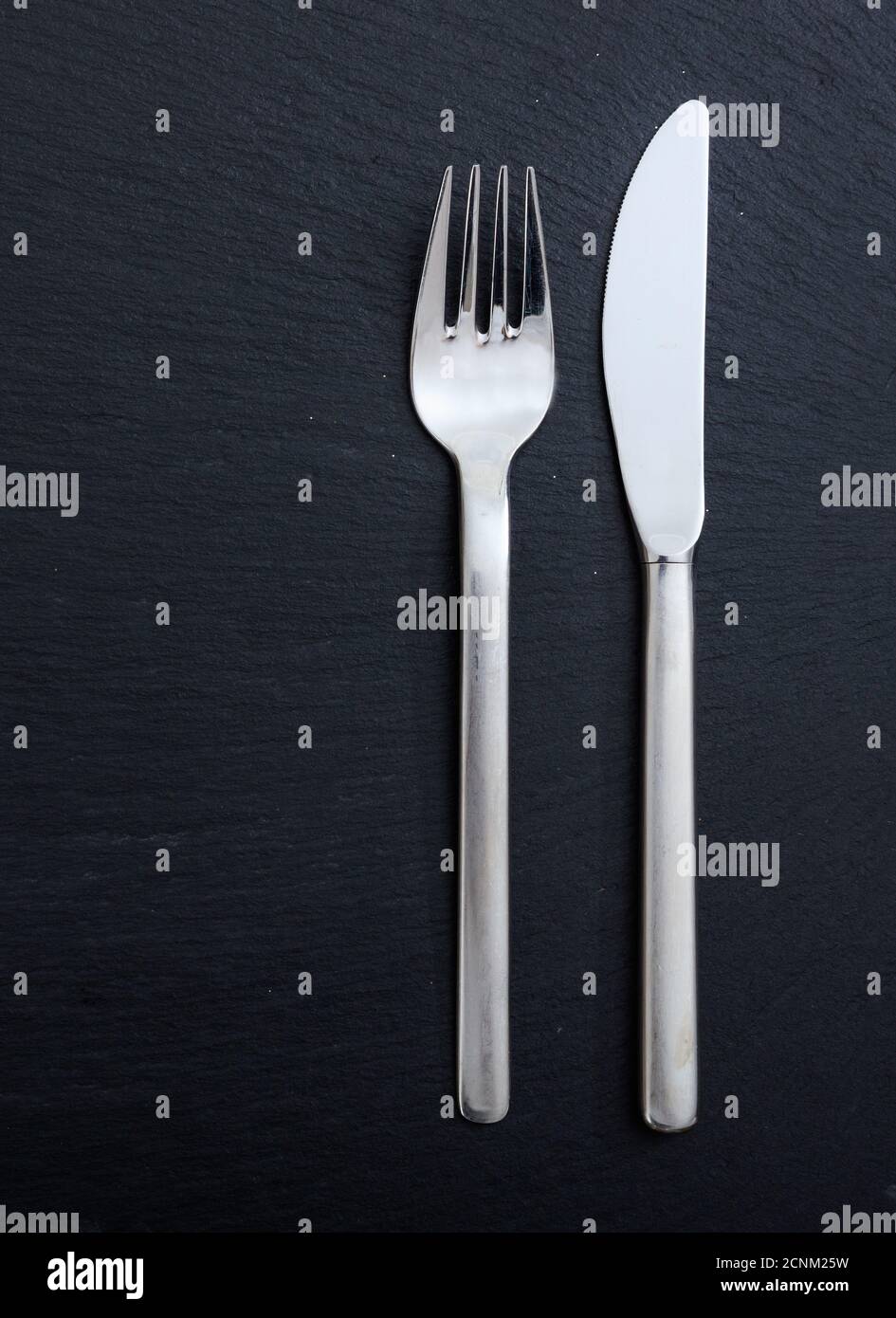Table setting, business lunch. Fork and knife isolated on black