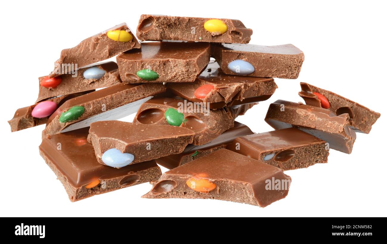 Cube milk chocolate with colorful dragee Isolated on a white background. Stock Photo